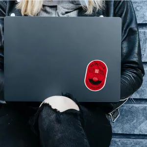 Sticker of the campaign logo in red, sticking on a laptop