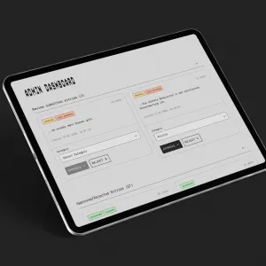 Ein Tablet zeigt eine Webseite mit Formularfeldern und orangefarbenen Schaltflächen auf grauem Hintergrund. Das Interface präsentiert verschiedene Eingabefelder und Steuerelemente für eine Anwendung oder ein Verwaltungssystem.