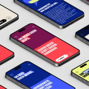 Smartphone Screens mit ihrer für den Demo-Mat typischen Zweiteilung des Bildschirms in zwei Farben, eine Bildschirmhälfte für jeden Satzteil.