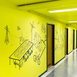 The illustrations of renewable energy sources connect the three doors along the corridor