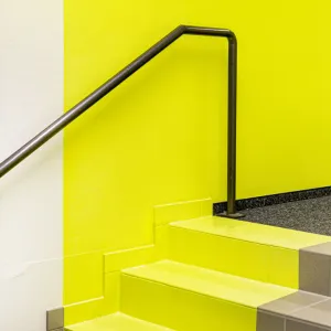 Color detail in the corridor entrance, also the stairs are partly painted neon yellow to achieve a perspective effect