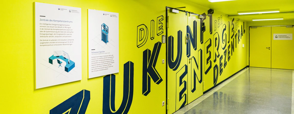 Yellow wall with large dark blue letters displaying the text “The future of energy is decentralized” across the entire corridor wall