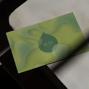 Green business card with wave-like drops and the RUH logo in the center