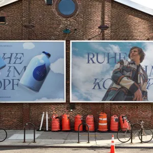 Out-of-home posters advertise the blue RUH variant, with decorative cloud elements and dark blue curved lettering