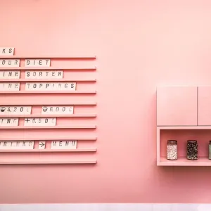 Pink wall behind the counter, with letter boards on which the menu is arranged in individual letters